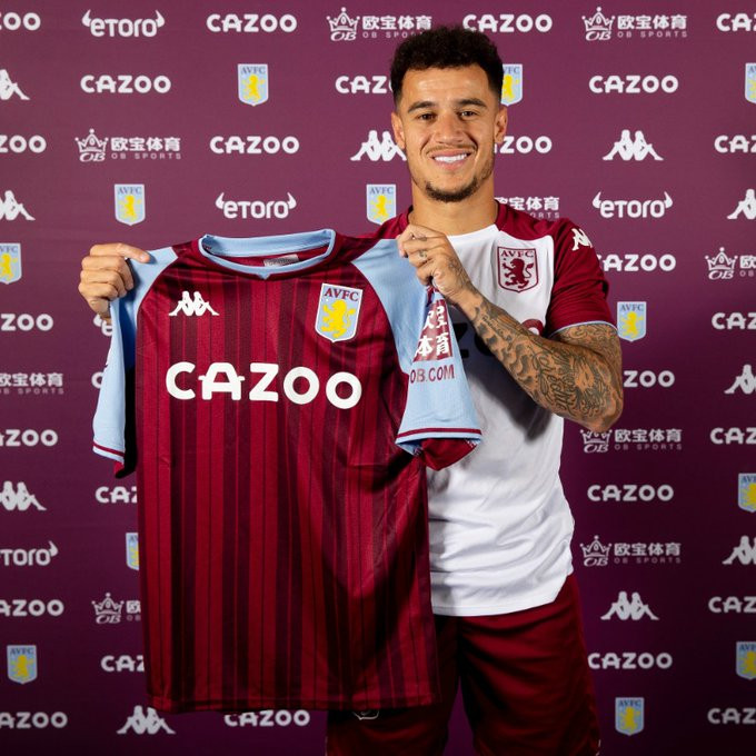 Phillippe Coutinho posting with an aston villa jersey after making his move from Barcelona permanent.