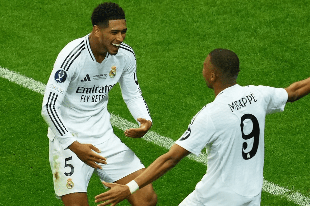 Real Madrid forward Kylian Mbappe scores and celebrates with Jude Bellingham in the Supercup final